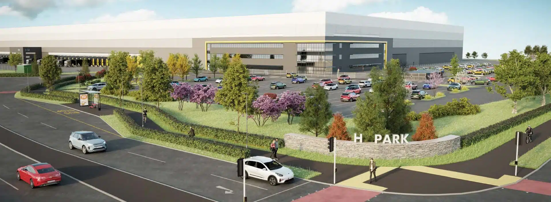 Modern industrial building with parking and landscaped garden.