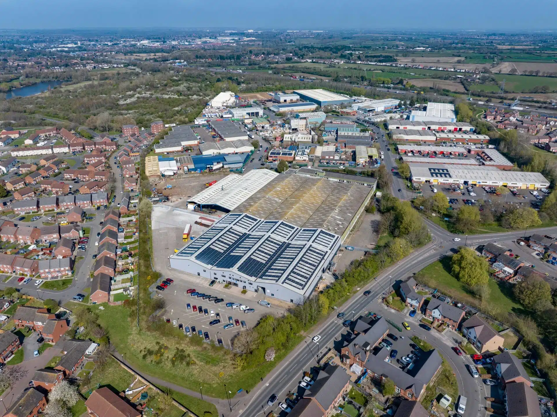 Aerial view of industrial estate and houses.