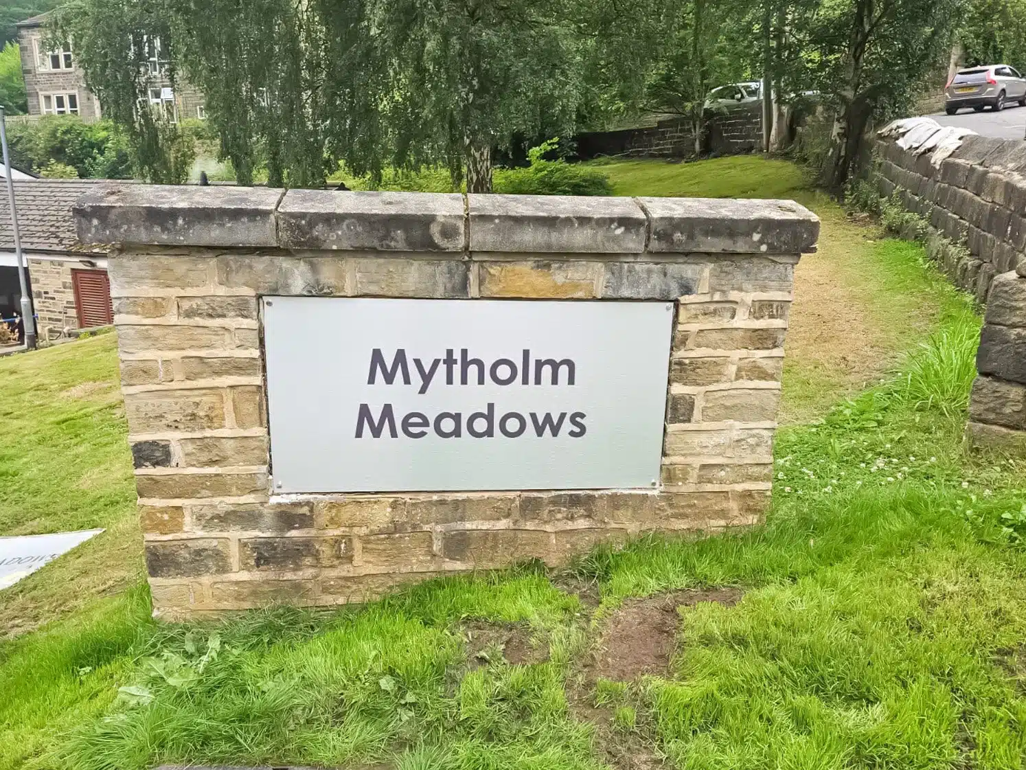 Stone sign reading 'Mytholm Meadows'
