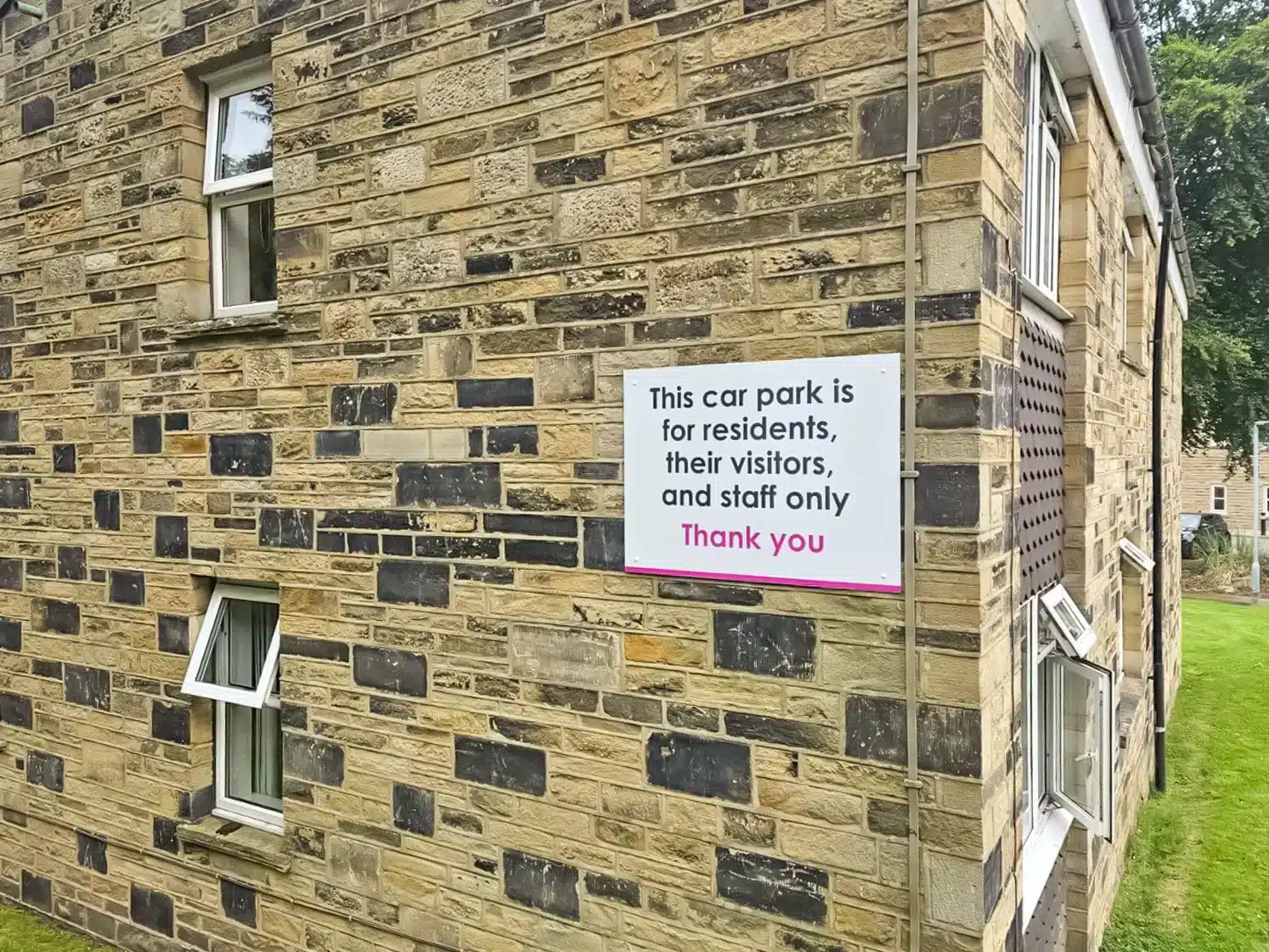 Stone building with car park sign