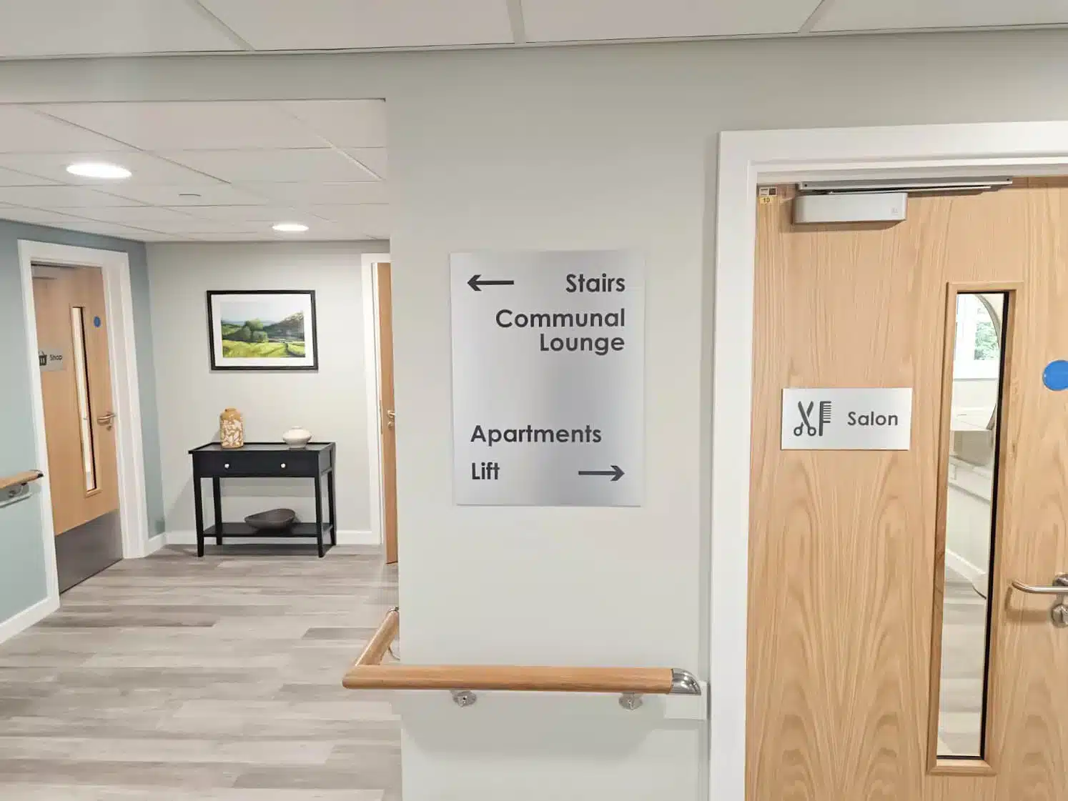 Corridor with signs to various facilities.