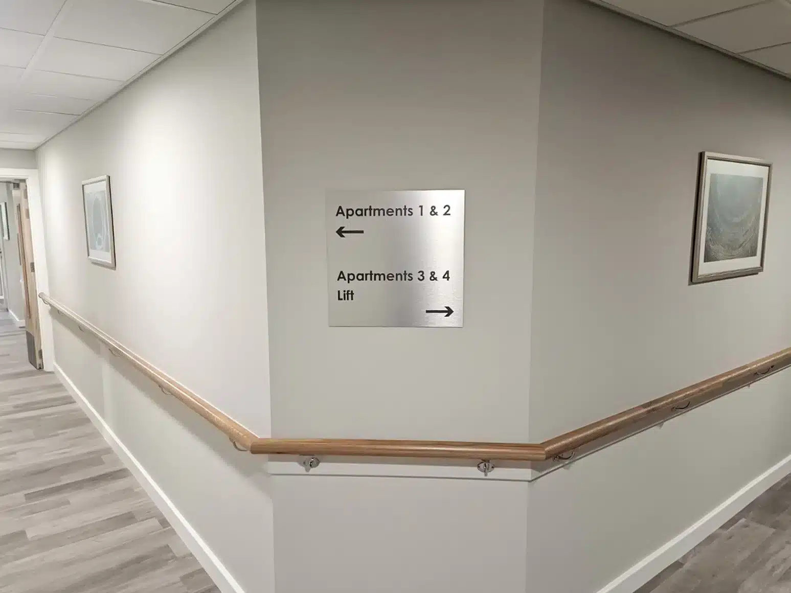 Corridor with sign for apartment directions