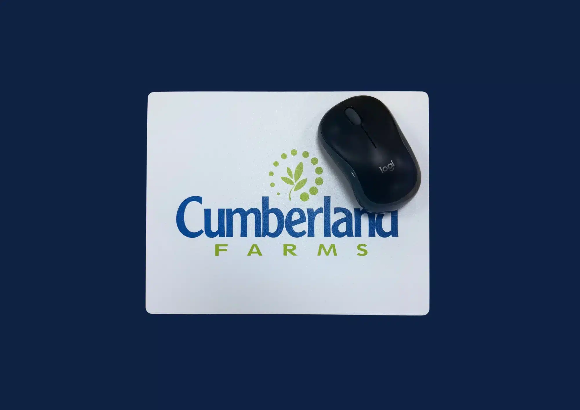 Black Logitech mouse on Cumberland Farms branded mouse mat