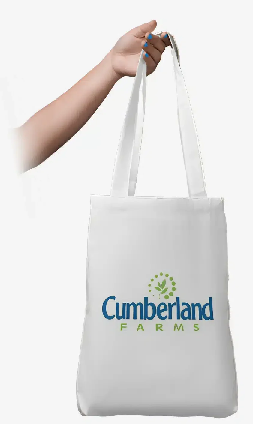 Hand holding Cumberland Farms branded white tote bag