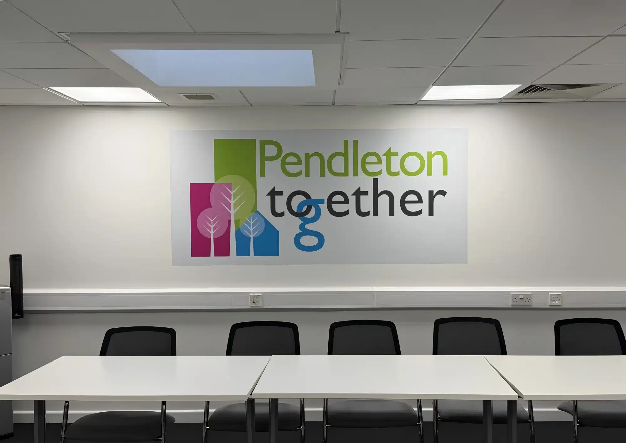 Pendleton Together logo in a modern meeting room